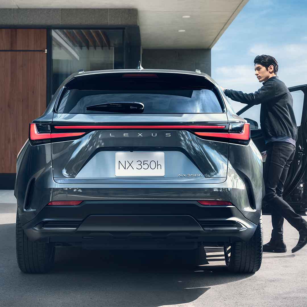 Rear view of the new NX - a man opens the driver's door.