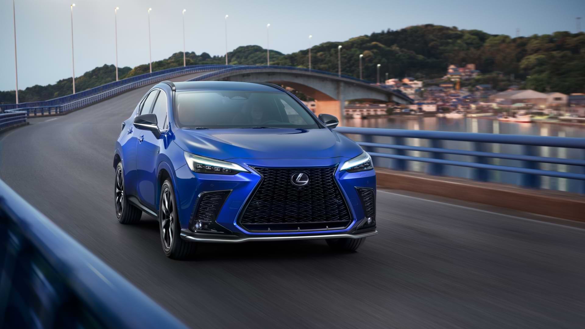 Blue 2021 Lexus NX driving over a bridge