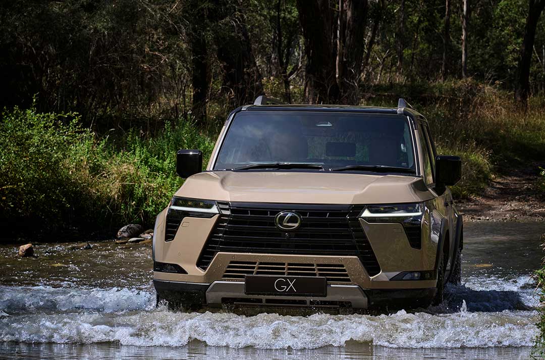 Earth coloured Lexus GX drives through a fresh water crossing